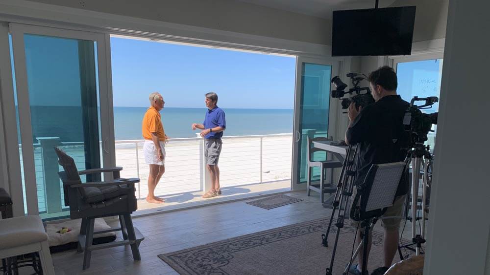 Crew films owners Dr. Lebron Lackey and Russell King on their beachfront balcony.